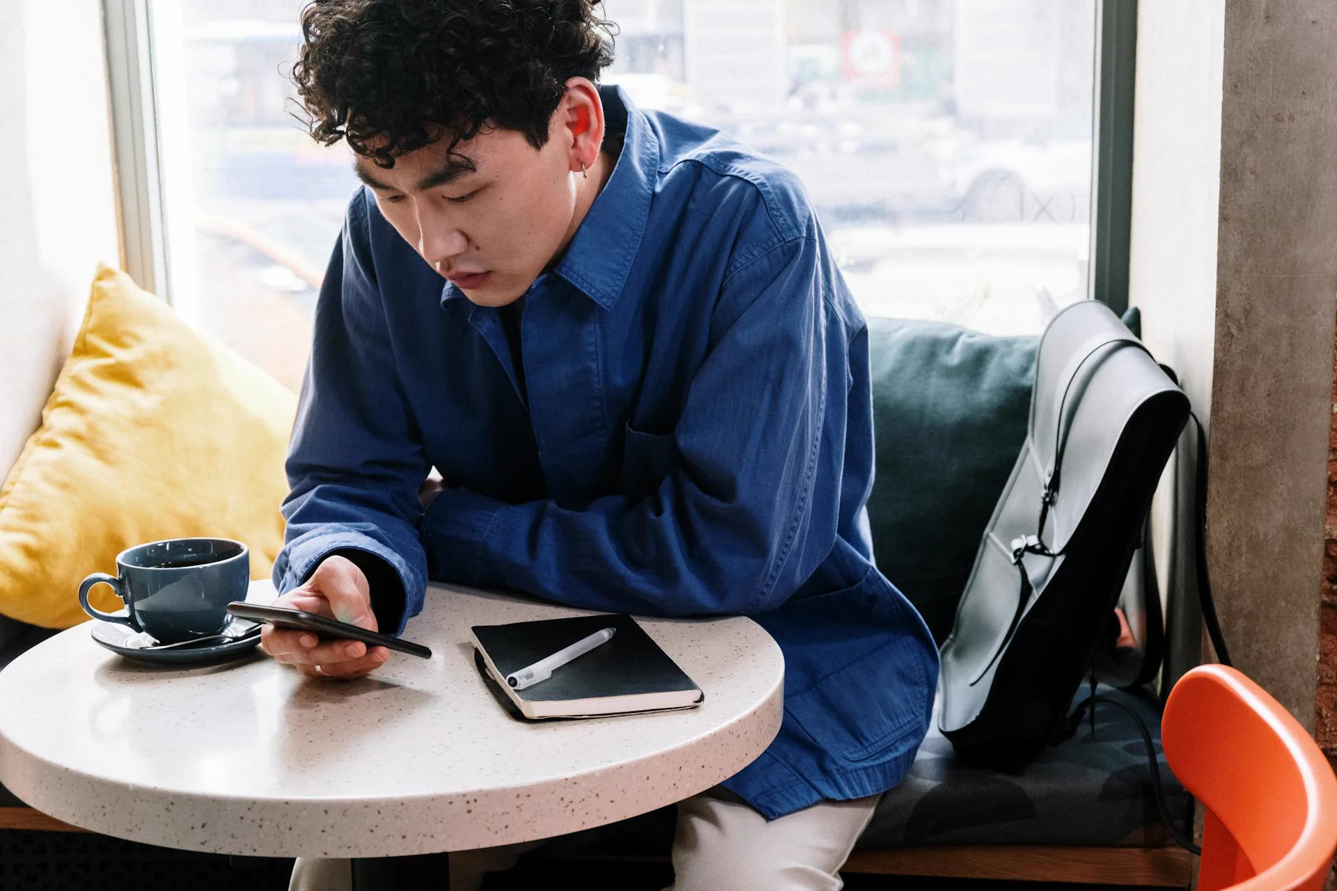 Traveler at a cafe asking the AI Explorer a question on their phone